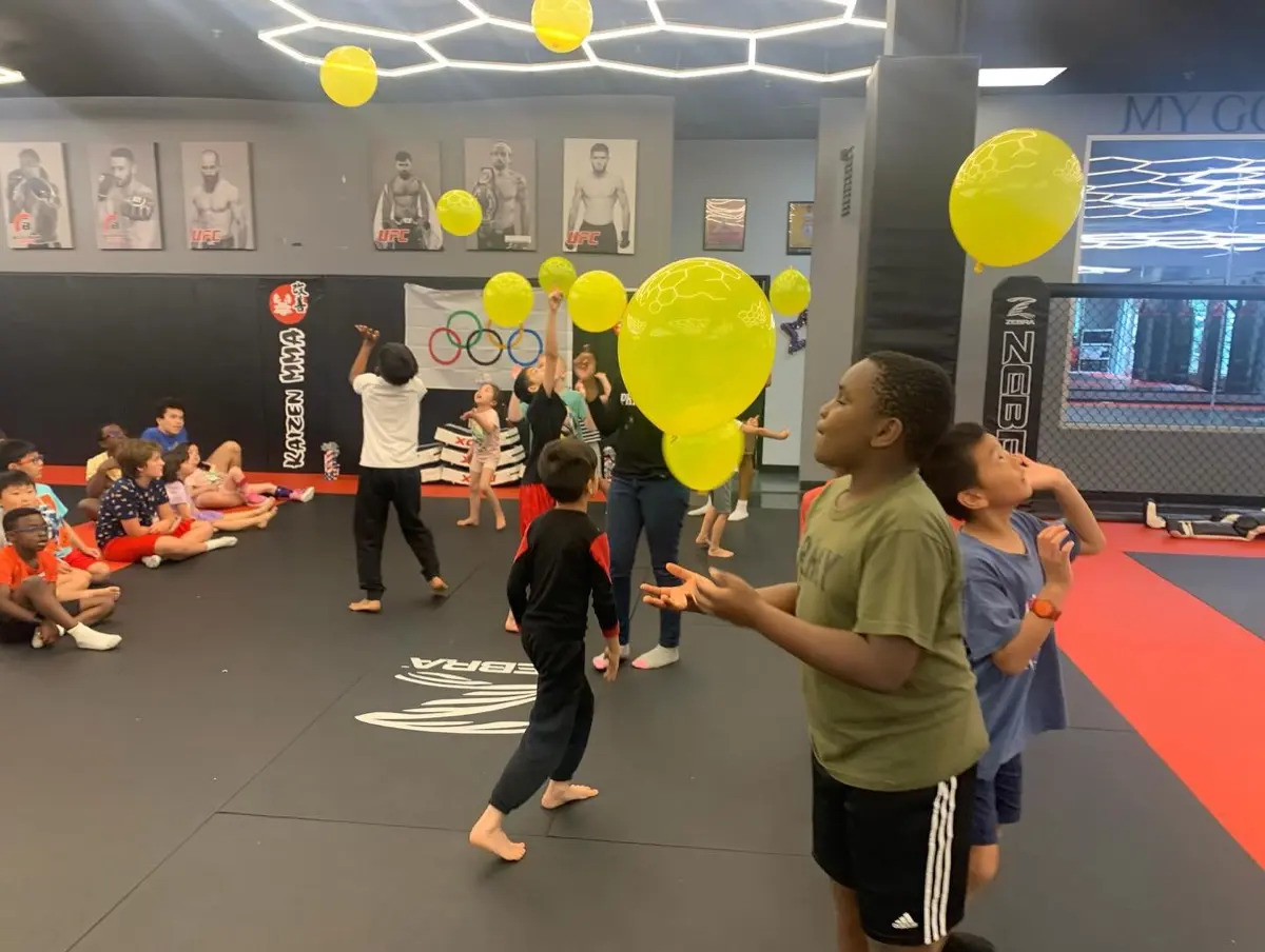 Kids having fun with balloons at summer camp