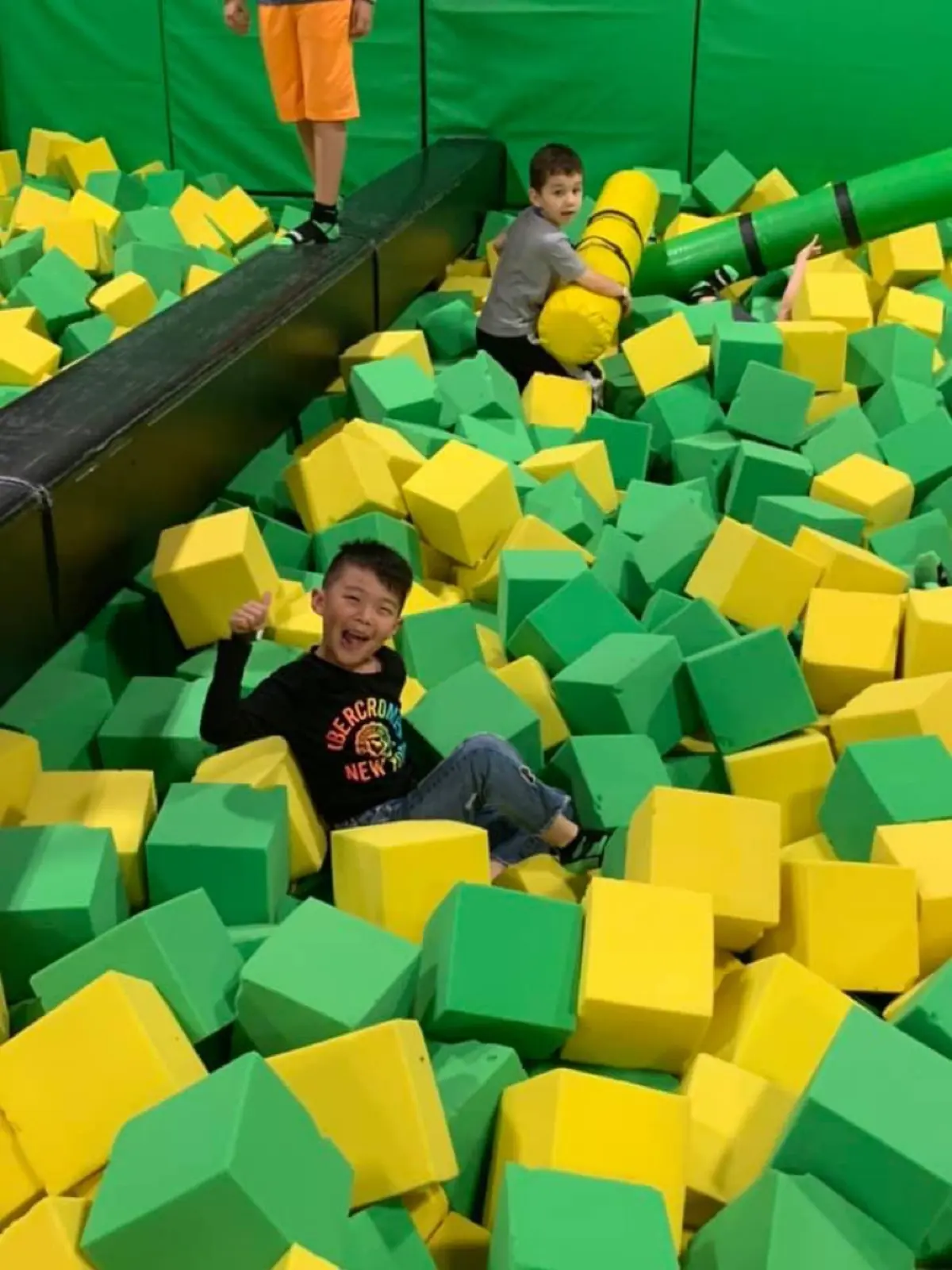 Summer camp kids in foam pit at trampoline park field trip