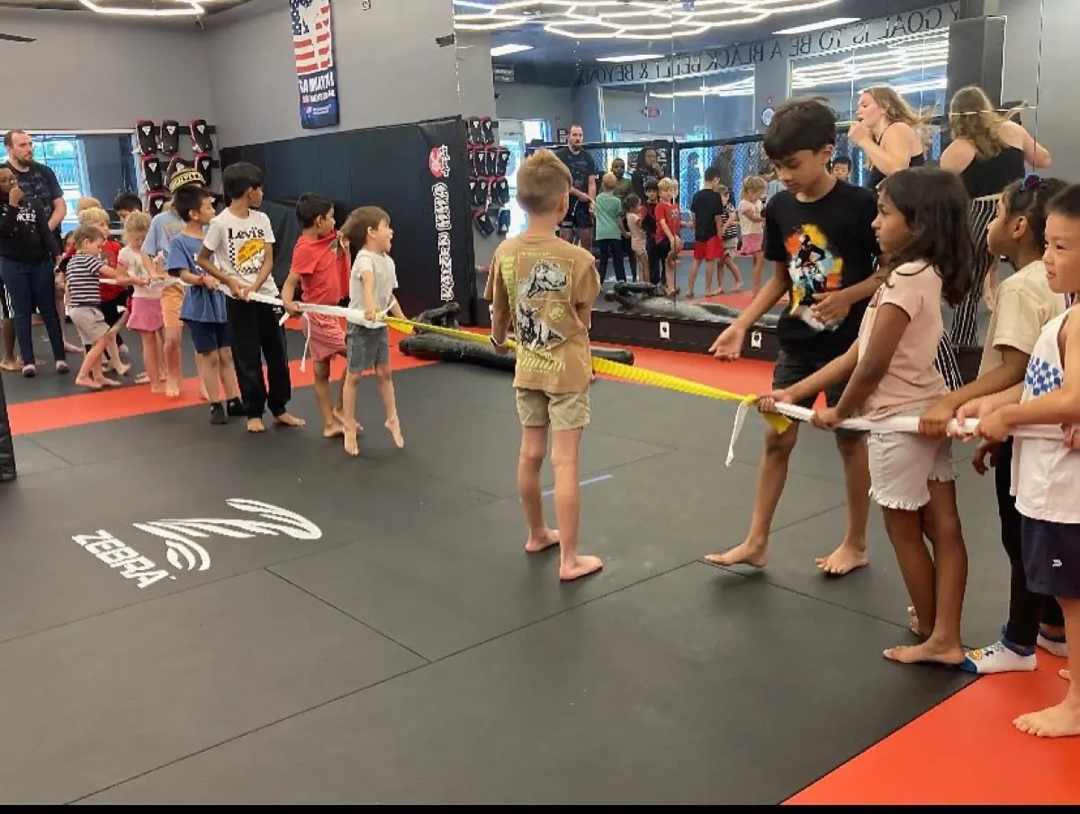 Kids playing tug of war at Kaizen MMA summer camp